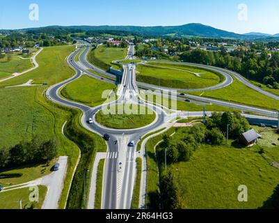 New highway junction in Poland on national road no 7, E77, called Zakopianka.  Overpass crossroad with traffic circles, slip ramps and viaducts near R Stock Photo