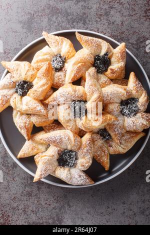 Finnish star-shaped joulutorttu christmas cake with dried marmalade close-up in a plate on a table. Vertical top view from above Stock Photo