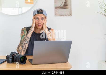 A photographer on laptop lost camera files Stock Photo