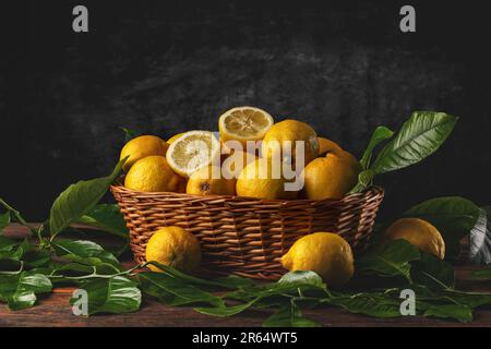 Fresh lemons in wooden basket with space for your text Stock Photo
