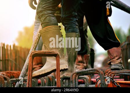 Construction worker pouring cement or concrete with pump tube at construction site Stock Photo