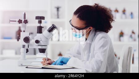 Science, writing and woman scientist with microscope for research, medicine and data analysis in lab. Laboratory, healthcare and lady health expert Stock Photo