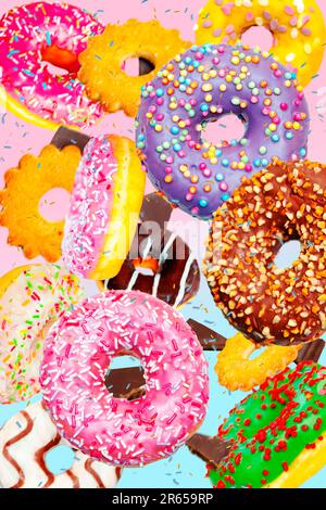 Flying colorful donuts, cookies and chocolates on a blue and pink background. Stock Photo