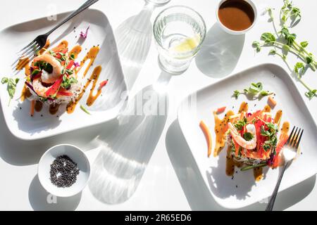 Deconstructed salad rolls served with Asian dressing and black sesame seeds. Stock Photo