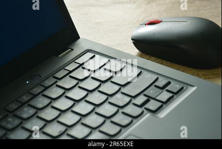 laptop and computer mouse on wooden table Stock Photo