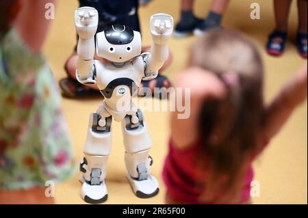 Karlsruhe, Germany. 07th June, 2023. The humanoid robot 'NAO' is introduced in the inclusive daycare center at the Lebenshilfehaus Karlsruhe. There, it accompanies the children in their everyday life. The project is part of the Real Lab Robotic AI of the Karlsruhe Institute of Technology (KIT), which makes artificial intelligence (AI) and robotics tangible for all people. Credit: Uli Deck/dpa/Alamy Live News Stock Photo