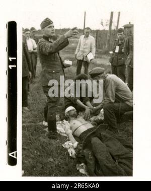 SS Photographer Baumann, Totenkopf Division, Russia 1941 Wheeled reconnaissance unit , photos of motorcycles, flak guns, graves, Russian prisoners of war and villagers, Fieseler Fi 156 Storch, destroyed Russian tanks and equipment, bridge building, soldiers swimming in river, machine gun crew, anti-tank gun crew, unit awards ceremony, units on the march, artillery towed by halftracks, motor vehicle maintenance unit, Kriegsberichter activities, field bakery, field hospital, air resupply by JU-52, antiaircraft searchlight unit, field post office, and a  Focke-Wulf 189 (Eagle-Owl) in flight.  Ima Stock Photo