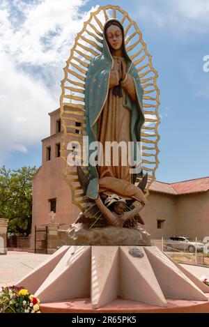 12-foot tall 2008 bronze statue, Nuestra Senora (Our Lady) de Guadalupe by Mexican artist Doña Georgina Farias in front of the Santuario de Guadalupe. Stock Photo