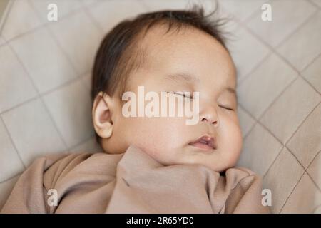 Portrait of cute baby boy sleeping on his bed Stock Photo