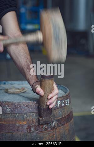 Hammer and chisel on whisky barrel Stock Photo