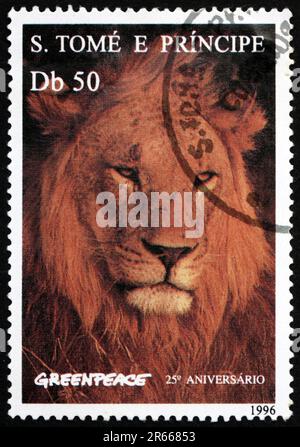 SAO TOME AND PRINIPE - CIRCA 1996: a stamp printed in Sao Tome and Principe shows lion, panthera leo, big cat, Greenpeace, 25th anniversary, circa 199 Stock Photo