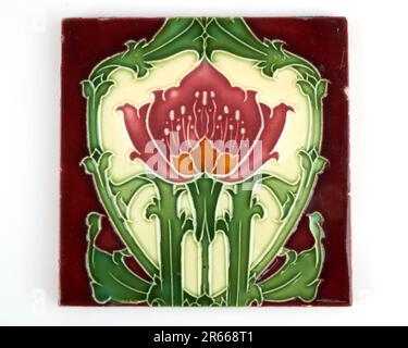 Antique 1900s Art Nouveau Minton red and amber poppy pottery tile Stock Photo