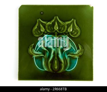 Antique 1900s Art Nouveau Minton three green flower pottery tile Stock Photo