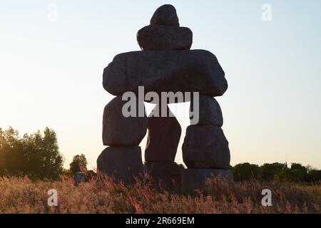 Stacked stones artwork De Baak by artist Rob Schreef in Lutjegast during sunset Stock Photo