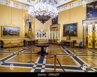 The Queen's room with his rare Rococo white and gilt stucco decoration ceiling and Neapolitans School paintings of the 17th-18th century - Royal Palace of Naples that In 1734 became the royal residence of the Bourbons - Naples, Italy Stock Photo