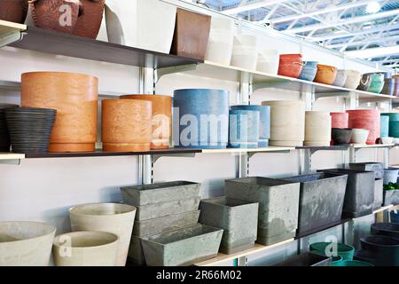 Large pots of clay and artificial stone in the store at the exhibition Stock Photo