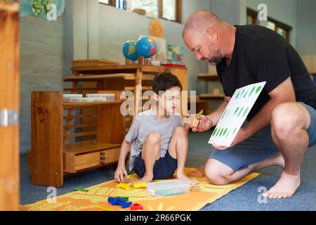 Father and son with Down Syndrome learning about plants Stock Photo