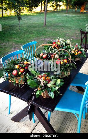 Edible bouquets made by food florists at the master class stand on a wooden table Stock Photo