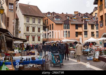 Annecy, France - January 29, 2022: People buying and selling at the old town market of Annecy, France. Stock Photo