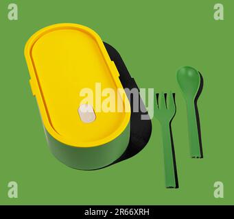 Lunch box and fork, spoon utensils. Green lunchbox container, food package. Stock Photo