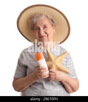 Senior woman with sunscreen cream and starfish on white background Stock Photo