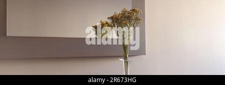 Beautiful bouquet of yellow wildflowers in transparent vase Stock Photo