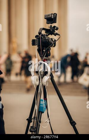 A high resolution closeup shot of a professional video camera mounted on a tripod,  ready for use Stock Photo