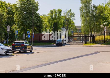 View of security cars in front of entrance to Russian Embassy metal fence. Stockholm, Sweden. Stock Photo