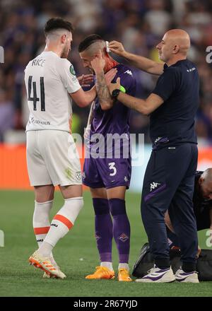 Prague, Czech Republic. 7th June, 2023. Cristiano Biraghi of ACF Fiorentina receives treatment for a wound to the head after allegedly being struck by a cigarette lighter whilst attempting to take a corner kick in front of West Ham United fans during the UEFA Europa Conference League match at the Eden Arena, Prague. Picture credit should read: Jonathan Moscrop/Sportimage Credit: Sportimage Ltd/Alamy Live News Stock Photo
