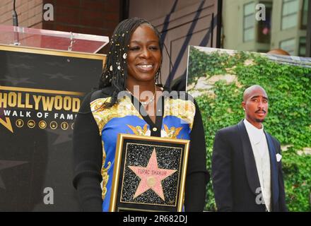 Sekyiwa "Set" Shakur holds a plaque at a ceremony honoring her brother