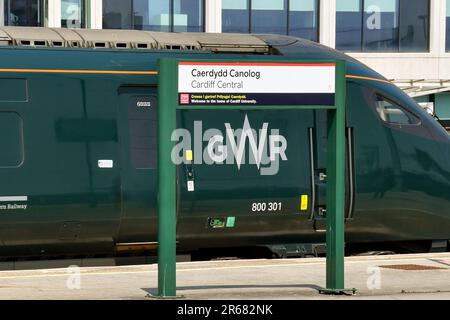 Cardiff, Wales - June 2023: High speed train operated by Great Western Railway alongside a platform sign for Cardiff Central railway station Stock Photo