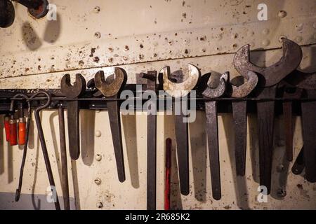 Close up of tools hanging on wall indoors Stock Photo