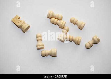 chess pieces, knight and pawns laying on a white background Stock Photo