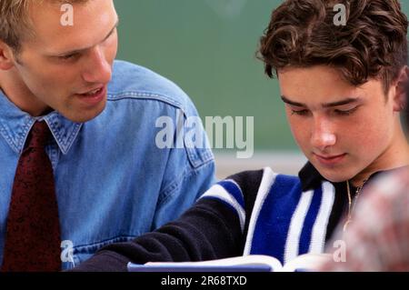 High School teacherhelping a student in class Stock Photo
