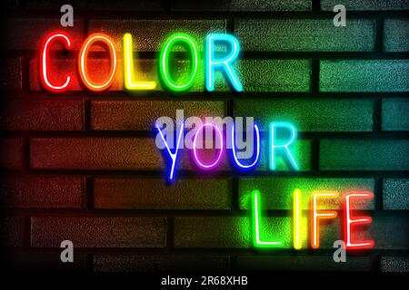 Glowing neon sign with phrase Color Your Life on brick wall Stock Photo
