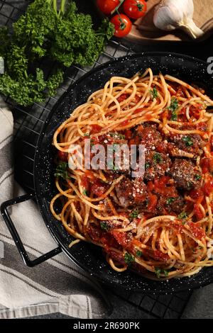 Delicious pasta with meatballs and tomato sauce near ingredients on grey table, flat lay Stock Photo