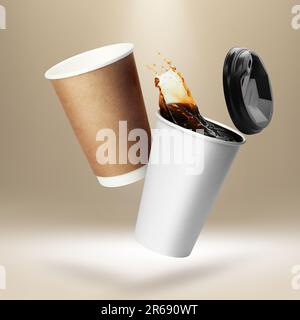 Takeaway paper cups falling on beige background Stock Photo