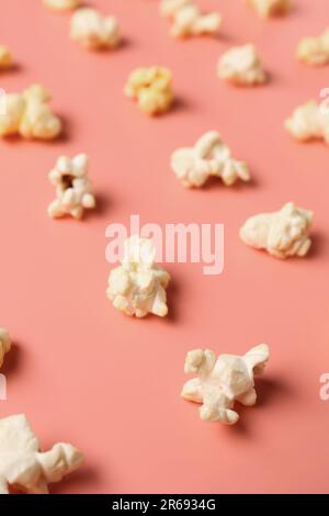 Crispy popcorn on pink background Stock Photo