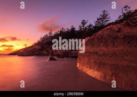 a sunset over a body of water on magnetic island in australia Stock Photo