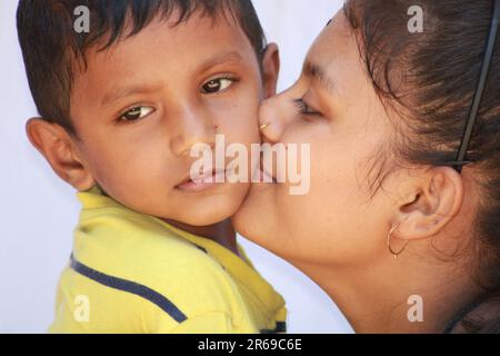 Indian girl kissing  a little boy cheek Stock Photo