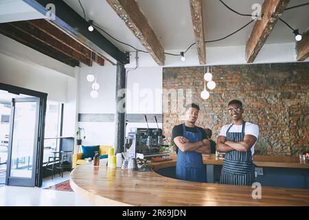 Behind great coffee is a great barista. two confident young men working in a cafe. Stock Photo