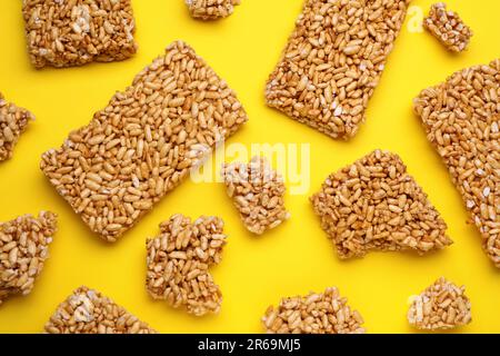 Puffed rice bars (kozinaki) on yellow background, flat lay Stock Photo