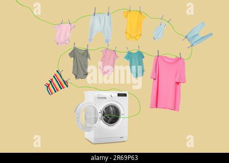 Drying laundry. Rope with children clothes flying out from washing machine on beige background Stock Photo