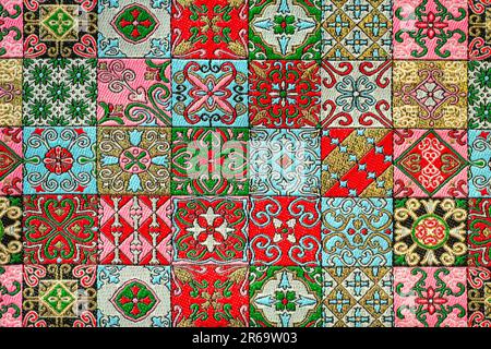 Decorative abstract fabric colorful background with ornate varied geometric floral pattern. Turkish ethnic ornament carpet design, rich fabric and tex Stock Photo