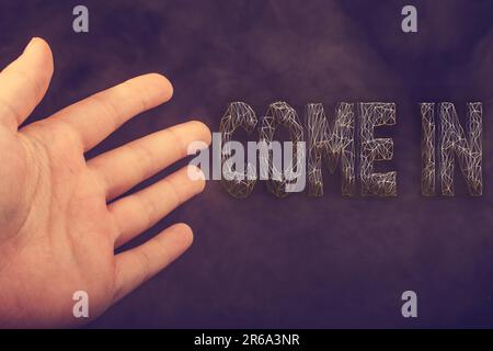 Hand Lettered Come In Hand making welcome gesture saying come in Stock Photo - Alamy