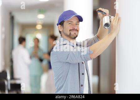 professional cctv technician working in hospital Stock Photo