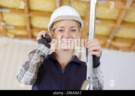 young woman builder holding walkie talkie Stock Photo
