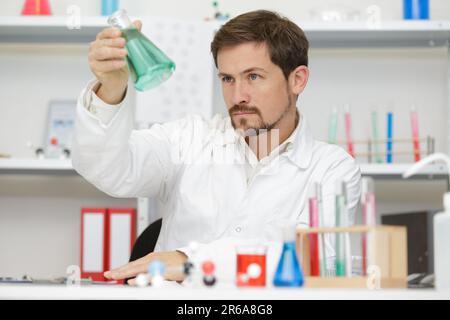 two scientists doing experiments with chemical liquid in the lab Stock Photo