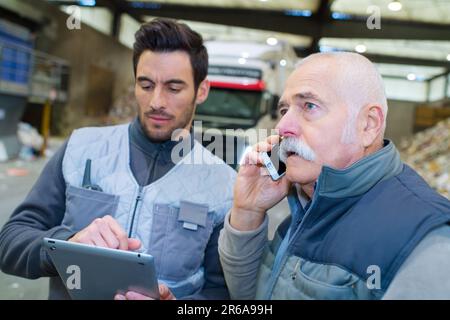 workers talking in recycling factory Stock Photo