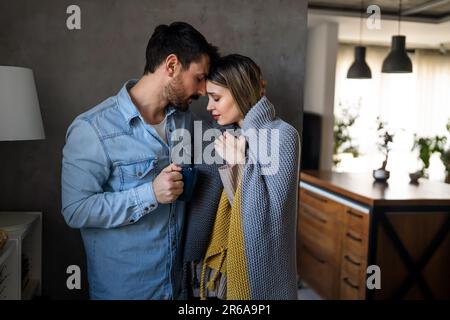 Freezing man and woman suffering from cold or flu fever or having trouble with central heating Stock Photo
